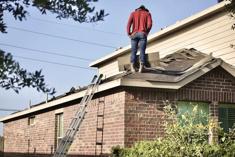 Professional roofer working on a residential roof in Toughkenamon